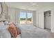 Bright bedroom features large windows with scenic view, closet, and modern light fixture at 11912 Vale St, Indianapolis, IN 46235