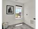 The laundry room features gray tile floors, a bright window, and a black and white photograph at 11912 Vale St, Indianapolis, IN 46235