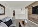 View of the stylish living room showcases an open layout to other rooms and a wood accent wall at 11912 Vale St, Indianapolis, IN 46235
