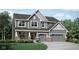 Charming two-story home with gray siding, brick accents, and a two-car garage at 1239 Thornwood Dr, Greenwood, IN 46143