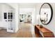 Bright foyer with wood-look flooring, console table with decorative mirror, and a view of the living room at 1239 Thornwood Dr, Greenwood, IN 46143
