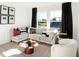 Stylish living room features modern furniture, decorative pillows, and ample natural light at 1239 Thornwood Dr, Greenwood, IN 46143