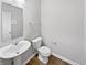 Powder room features a pedestal sink, mirror and hardwood floors at 1276 Sanderling Dr, Greenwood, IN 46143