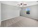 Inviting bedroom featuring a ceiling fan, plush carpeting, and a window with a pleasant outdoor view at 1276 Sanderling Dr, Greenwood, IN 46143