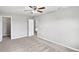 This spacious bedroom has plush carpeting, neutral-painted walls, and a ceiling fan with lighting at 1276 Sanderling Dr, Greenwood, IN 46143