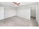 A well lit bedroom featuring a ceiling fan, neutral-painted walls, plush carpeting, and a closet at 1276 Sanderling Dr, Greenwood, IN 46143