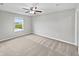 Bright and airy bedroom with neutral walls, carpet flooring, and a large window at 1276 Sanderling Dr, Greenwood, IN 46143