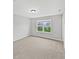 Bright bedroom with a neutral color scheme, plush carpeting, and a window view of the neighborhood at 1276 Sanderling Dr, Greenwood, IN 46143