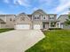 Charming two-story home with brick and siding and an attached three-car garage at 1276 Sanderling Dr, Greenwood, IN 46143
