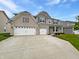 Charming two-story home with brick and siding and an attached three-car garage at 1276 Sanderling Dr, Greenwood, IN 46143