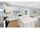 Spacious kitchen features white cabinets, quartz countertops, a center island and stainless appliances at 1276 Sanderling Dr, Greenwood, IN 46143