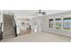 Open floor plan of the living room with adjacent kitchen, dining area, and staircase at 1276 Sanderling Dr, Greenwood, IN 46143