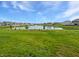 Picturesque pond view with fountain surrounded by mature trees and lush green grass at 1276 Sanderling Dr, Greenwood, IN 46143