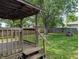 Cozy wood deck and fenced yard with mature trees offer outdoor relaxation and entertainment possibilities at 1280 Maple Ct, Martinsville, IN 46151