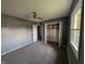 This bedroom features neutral carpet, gray walls, a ceiling fan, and closet space at 1280 Maple Ct, Martinsville, IN 46151