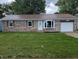 Charming brick home features a red roof, bay window, well-kept lawn, and an attached one car garage at 1280 Maple Ct, Martinsville, IN 46151