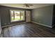 Inviting living room features gray walls, sleek flooring, a fan, and a bright window at 1280 Maple Ct, Martinsville, IN 46151