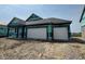New construction home featuring a two-car garage, black trim, and architectural roofing at 1351 Foxtail Ln, Greenwood, IN 46143