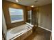 Bright bathroom featuring garden tub, shower, and tile flooring at 14462 Brook Meadow Dr, McCordsville, IN 46055