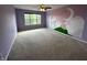 Spacious bedroom with playful mural wall decor, large window, and plush carpet at 14462 Brook Meadow Dr, McCordsville, IN 46055