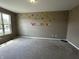 bedroom with playful wall decor, large window, and plush carpet at 14462 Brook Meadow Dr, McCordsville, IN 46055