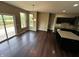 Bright dining area with hardwood floors, sliding doors to the deck, and black cabinetry at 14462 Brook Meadow Dr, McCordsville, IN 46055
