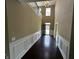 Bright foyer with dark hardwood floors, wainscoting, and a modern light fixture at 14462 Brook Meadow Dr, McCordsville, IN 46055