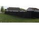 View of backyard, featuring lush lawn and tall wooden fence for added privacy at 1461 Ripplewood Dr, Danville, IN 46122