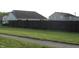 Fenced backyard with green lawn and partial shade, offering privacy and outdoor space at 1461 Ripplewood Dr, Danville, IN 46122
