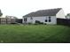 Relax in this backyard featuring green grass, patio, outdoor seating, and privacy fence at 1461 Ripplewood Dr, Danville, IN 46122