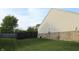 Backyard view with green grass, privacy fence, siding and brick at 1461 Ripplewood Dr, Danville, IN 46122
