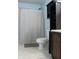 Bathroom featuring storage cabinet, toilet, shower with patterned curtain, and neutral flooring at 1461 Ripplewood Dr, Danville, IN 46122