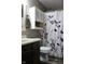 This bathroom features a vanity, toilet, and a shower with a decorative curtain, creating a pleasant and functional space at 1461 Ripplewood Dr, Danville, IN 46122