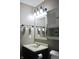Well-lit bathroom with a modern sink, mirror, vanity, and unique wall decor, enhancing the room's charm at 1461 Ripplewood Dr, Danville, IN 46122