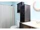 Bathroom featuring storage cabinet, shower with patterned curtain, and gold-toned mirror at 1461 Ripplewood Dr, Danville, IN 46122