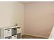 A minimalist bedroom featuring a modern storage unit, perfect for organization, and soft pink accent wall at 1461 Ripplewood Dr, Danville, IN 46122