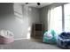 Bright bedroom featuring plush chairs, natural light, and a chalkboard for creative play at 1461 Ripplewood Dr, Danville, IN 46122