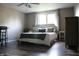Spacious main bedroom with hardwood floors, featuring a king-size bed, a dark dresser, and ample natural light at 1461 Ripplewood Dr, Danville, IN 46122