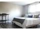 Bright bedroom with hardwood floors, featuring a king-size bed, desk space, and ample natural light creating a serene retreat at 1461 Ripplewood Dr, Danville, IN 46122