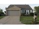 This property features a well-manicured lawn with a two car garage at 1461 Ripplewood Dr, Danville, IN 46122