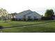 Exterior view of home with verdant front lawn, complemented by blue shutter accents at 1461 Ripplewood Dr, Danville, IN 46122