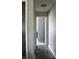 Bright hallway featuring wood-look flooring and neutral paint, leading to additional rooms at 1461 Ripplewood Dr, Danville, IN 46122