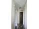 Hallway featuring wood-look flooring, neutral walls, and a dark closet at the end at 1461 Ripplewood Dr, Danville, IN 46122