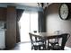 Cozy kitchen with dark wooden cabinets, a rustic dining table, and sliding door access to the outside at 1461 Ripplewood Dr, Danville, IN 46122
