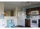 Functional kitchen area with modern appliances, wooden cabinets, and a playful play kitchen setup nearby at 1461 Ripplewood Dr, Danville, IN 46122