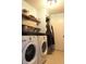 Bright laundry room featuring a white washer and dryer, shelving, and inspirational decor at 1461 Ripplewood Dr, Danville, IN 46122