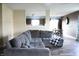 Inviting living room featuring a large sectional couch, wood floors, and an open view to the dining area at 1461 Ripplewood Dr, Danville, IN 46122