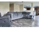 Spacious living room with hardwood floors, a comfortable sectional sofa, and inviting natural light at 1461 Ripplewood Dr, Danville, IN 46122