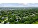 A scenic aerial view showcases neighborhood homes nestled among lush trees near local establishments at 14814 Beacon Blvd, Carmel, IN 46032
