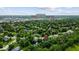 A scenic aerial view showcases neighborhood homes nestled among lush trees near The Monon Trail at 14814 Beacon Blvd, Carmel, IN 46032